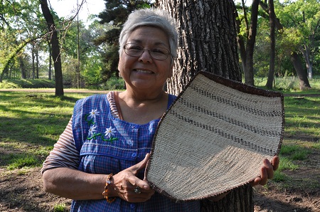 Julie Dick Tex in 2010 with her completed acorn sifting basket made during her apprenticeship with Avis Punkin.  Julie made this basket to replace an older worn one and to be used in her family’s acorn mush production.
