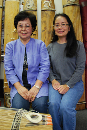 Master artist Katsuko Teruya Arakawa (left) and apprentice Pamela Joy Afuso, surrounded by Okinawan kutuus, at the Teruya Sokyoku Kenkyukai in Gardena.
