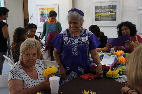 Master altarista Ofelia Esparza (center, standing) leads a paper flower workshop at the Boyle Heights Cultural Treasures celebration hosted by ACTA and Building Healthy Communities-Boyle Heights.