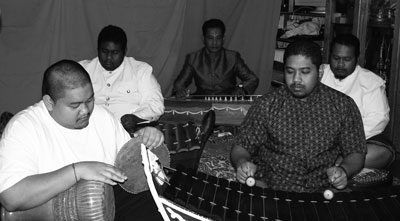 Photo of master roneat ek musician Sambath Pich and his four sons playing Khmer classical music.