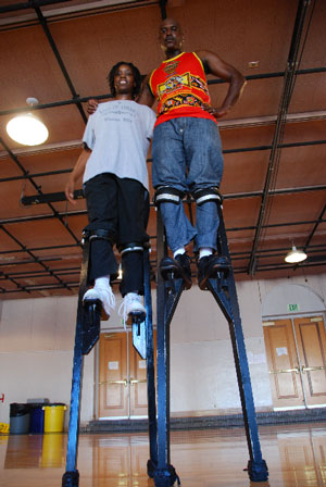 Master stilt dancer Shaka Zulu (right) and his 2009 apprentice Latanya Tigner.